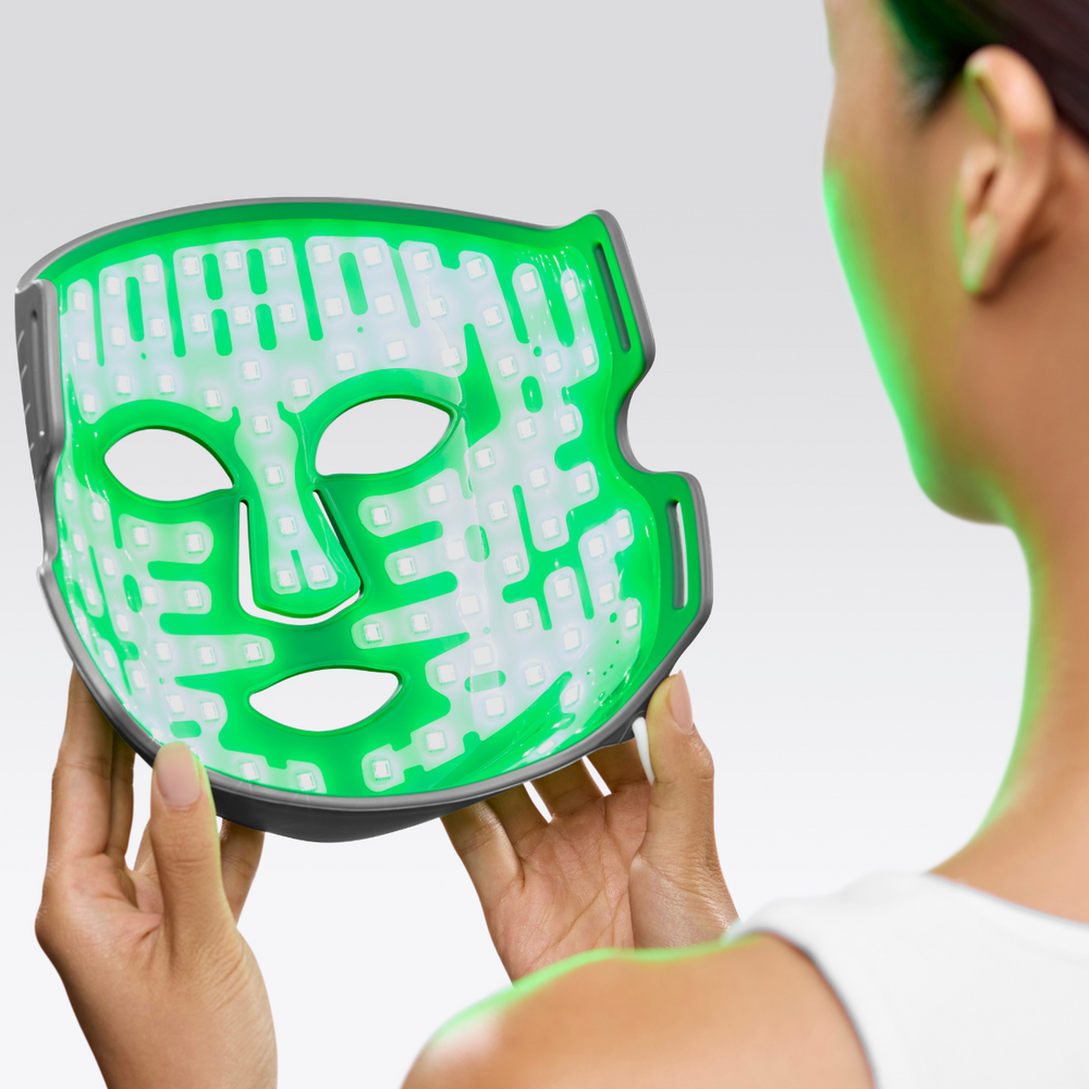 Woman holding LED Multi-Light Therapy Mask