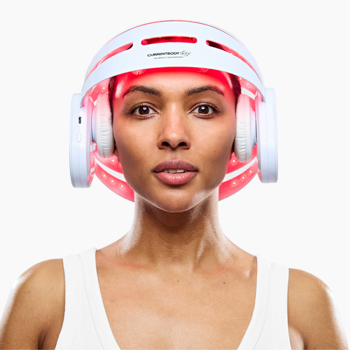 Woman using CurrentBody LED Hair Growth Helmet on her head