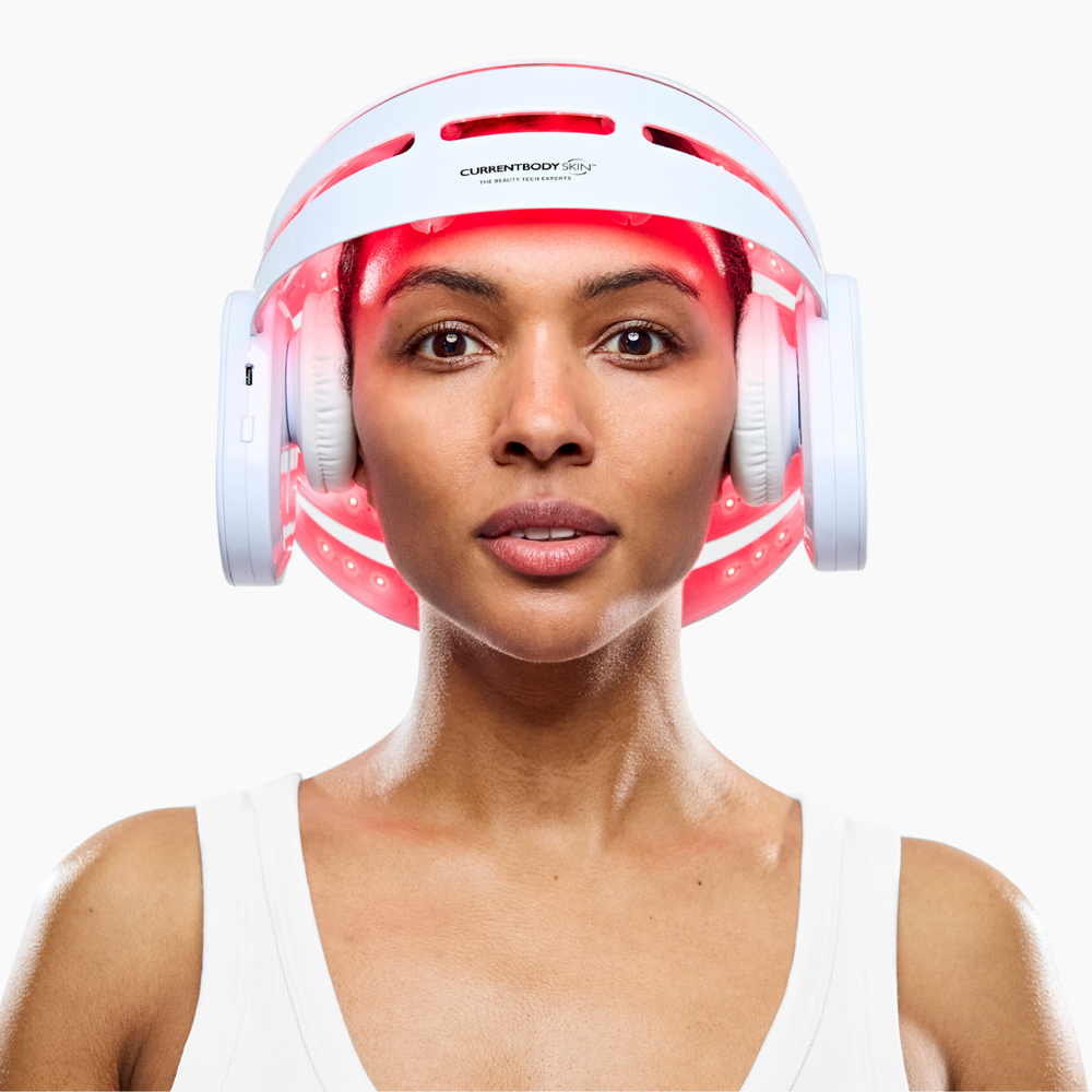 Woman using CurrentBody LED Hair Growth Helmet on her head